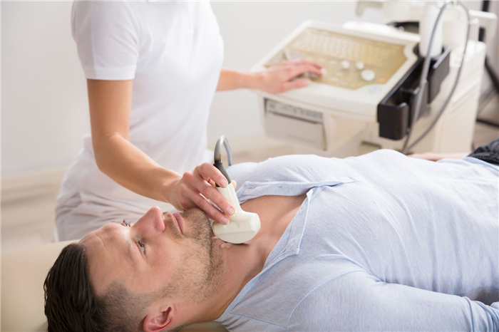 Young Man Getting Ultrasound Of A Thyroid