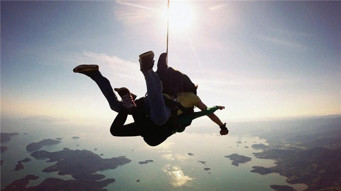 Skydiving tandem over the sea illustrating adrenaline and the endocrine system
